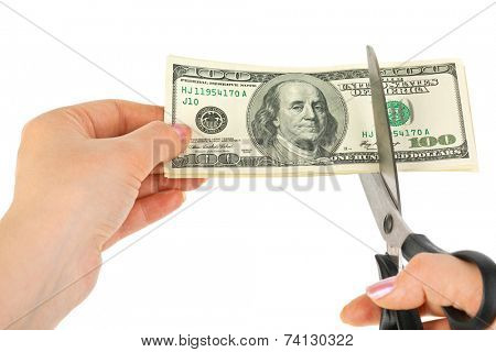 Hands with scissors cutting money isolated on white background