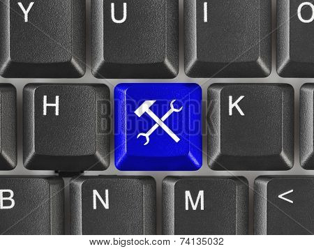 Computer keyboard with tools key - technology background