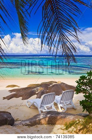 Chairs on tropical beach at Seychelles - vacation background