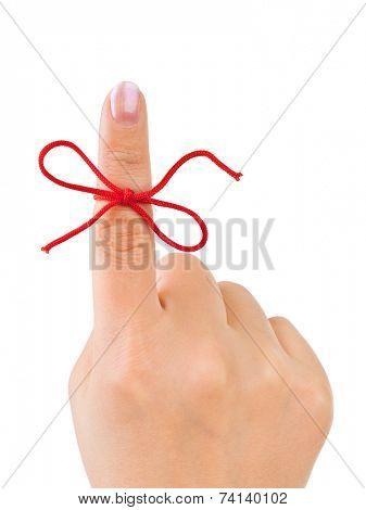 Red bow on finger isolated on white background