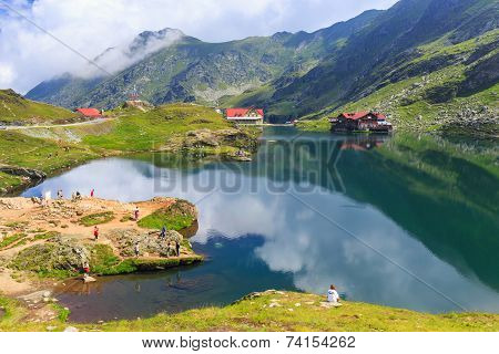 Unidentified tourists enjoy the sights of Balea Lake at 2034 m altitude
