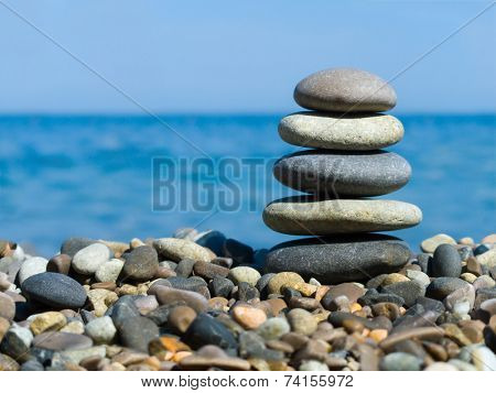 Stack of stones on beach, sea and sky