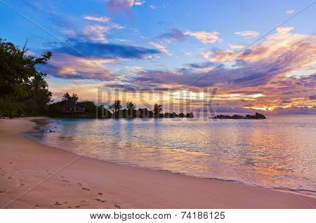 Cafe on Seychelles tropical beach at sunset - nature background