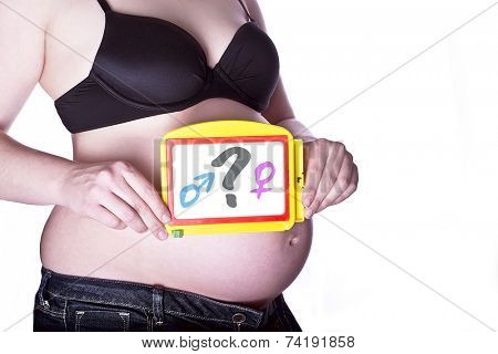 pregnant woman clothed in black bra and jeans holding a toy slate with a questionmark between gender symbols in front of her belly