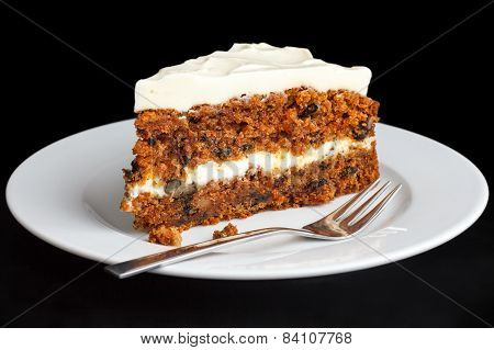 Slice of carrot cake with rich frosting.