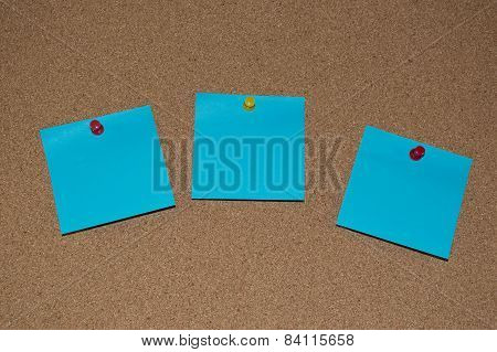 Blue Post it Notes on a Cork Board