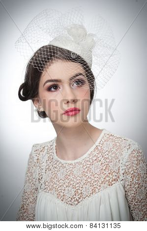 Hairstyle and make up - beautiful young girl art portrait. Cute brunette with white cap and veil