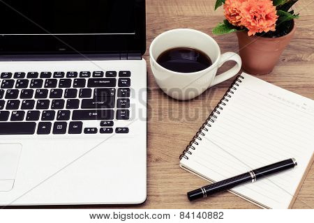 Laptop And Cup Of Coffee With Flower On Desk