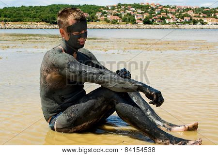 Man Applying Healing Clay