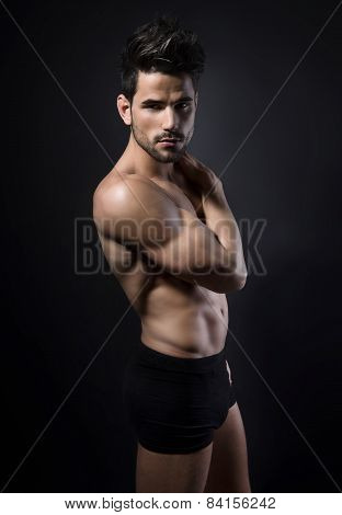 handsome young muscular man posing shirtless