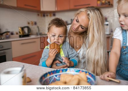 Mother With Kids On Kitchen