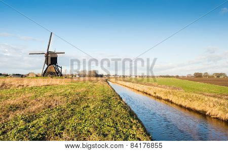 Dutch Polder Mill Against A Blue Sky