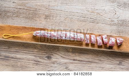 Cut Spanish Salami On The Wooden Board