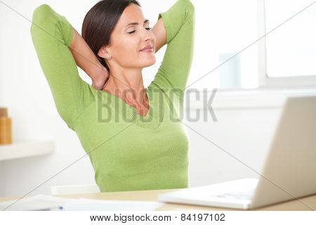 Elegant Hispanic Woman Resting On Desk