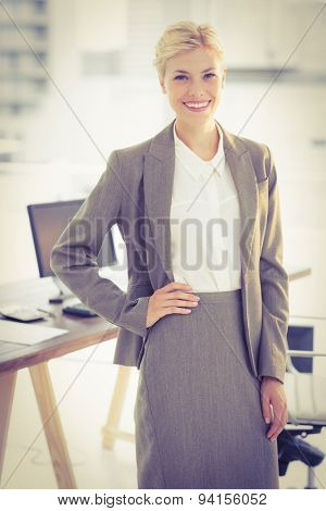 Smiling businesswoman lookingat camera in the office
