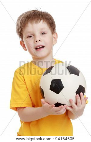 Cheerful little boy with a football in his hands