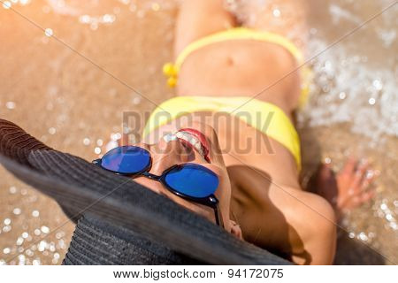 Woman engoying sun and water on the beach