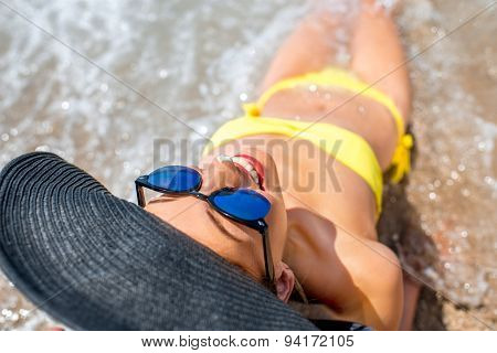 Woman engoying sun and water on the beach