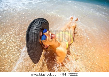 Woman engoying sun and water on the beach