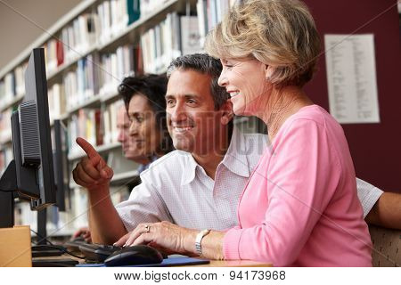 Students working on computers in library