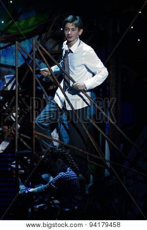 ST. PETERSBURG, RUSSIA - JUNE 19, 2015: Boy performing the role of Mowgli in a scene from a children's charity project titled Mowgli Generation. The performance is part of the SPIEF 2015