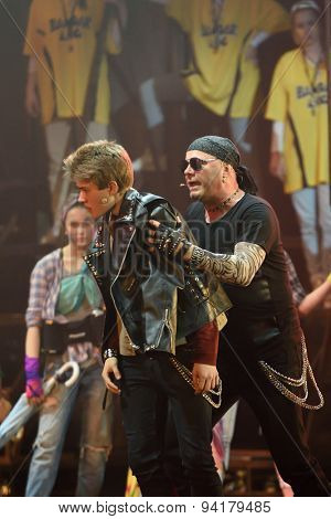 ST. PETERSBURG, RUSSIA - JUNE 19, 2015: Singer Alexey Kortnev (right) performs in a scene from a children's charity project titled Mowgli Generation. The performance is part of the SPIEF 2015