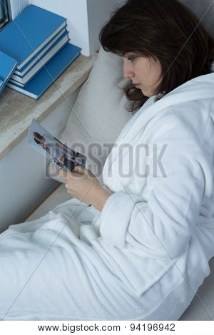 Depressed Woman Lying In Bed
