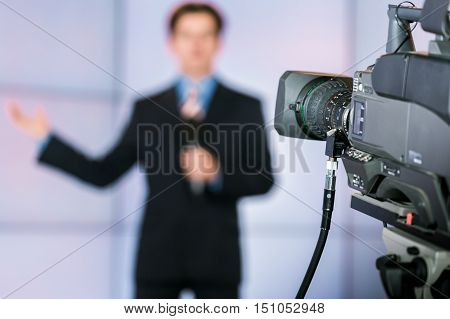 Closeup of a Video Camera Filming a TV Host