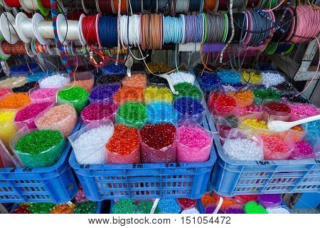 Colored thread ribbon beads in a shop.