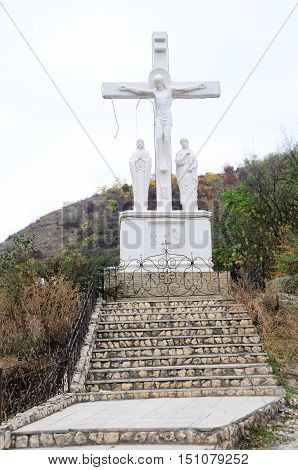 Ancient monastery. Village Saharna. Stone crucifix in orthodox monastery Saharna Republic of Moldova.