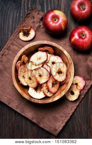 Baked dehydrated apples chips in wooden bowl healthy snack