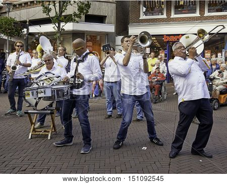 SNEEK, THE NETHERLANDS - OCTOBER 1, 2016: Dweilorkest De Knotwilgen performing at the streets of Sneek, during the annual Dweildag.