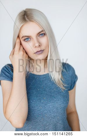 Vertical portrait of young beautiful woman with white hair posing over grey background. Clean t-shirt mockup