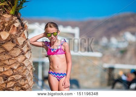 Adorable little girl at beach during summer vacation