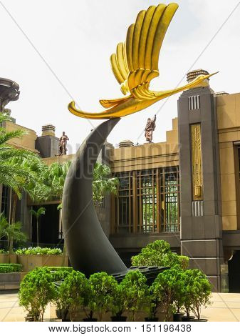 SINGAPORE, REPUBLIC OF SINGAPORE - JANUARY 10, 2014: Parkview Square is a landmark building in the Rochor-Bugis District, Singapore. In the middle of the open space there is a statue of a gold crane