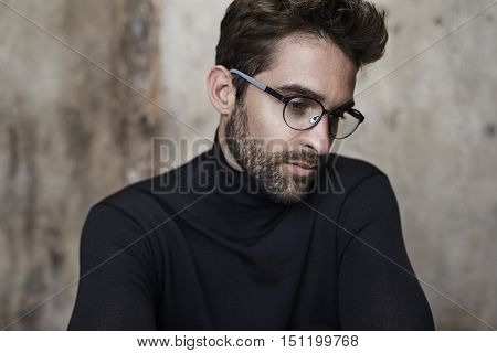 Bookish guy in black sweater and spectacles