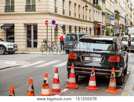 PARIS FRANCE - MAY 21 2016: Rear view of Bentley Bentayga Hybrid SUV on the streets of Paris France- street fastion