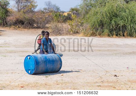 Caprivi, Namibia - August 20, 2016: Poor Teenagers Walking On The Roadside In The Rural Caprivi Stri