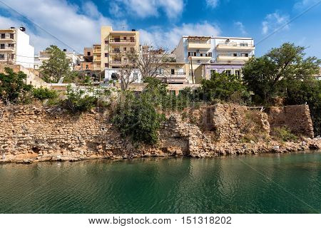 Greek houses on cliff of river channel at Sitia town on Crete island, Greece