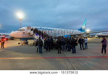 Moscow, Russia - October 5. 2016: Passengers boarding on the aircraft of low cost airline company Pobeda