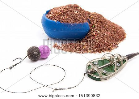 Dry Feed For Carp Fishing. Ready For Use Carp Bait With Fishing Flat Feeder For Carp Fishing Isolate