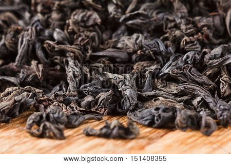 Background of dry black tea leaves. Ingredient beverage