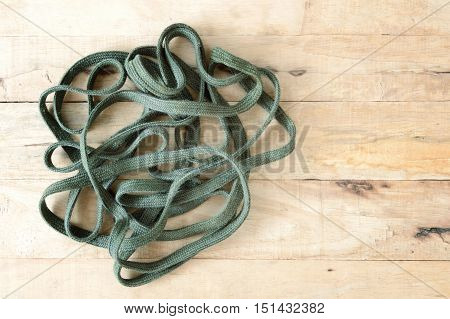 stack of green rope on wooden table