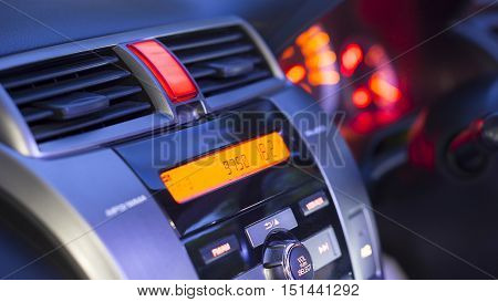 Transportation vehicle and car auto audio concept - Car audio and radio stereo system on car panel in evening ligth