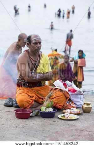 Rameswaram, Tamil Nadu, India - May 25, 2014. Full report about Rameswaram pilgrimage, religion. Religious city rituals. Priest on the beach side, offerings, prayer