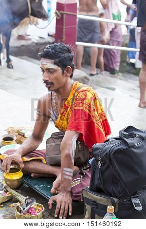 Rameswaram, Tamil Nadu, India - May 25, 2014. Full report about Rameswaram pilgrimage, religion. Religious city rituals. Priest on the beach side, offerings, prayer