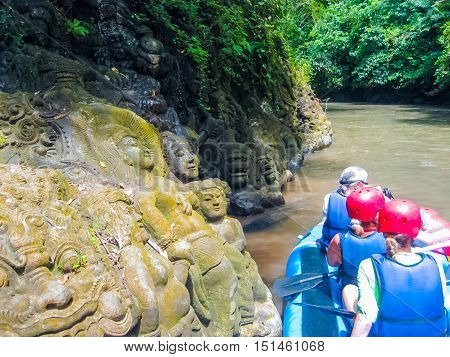 The rock bas-relief and rafting in the canyon on Balis mountain river Ayung at Indonesia