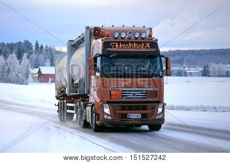 SALO FINLAND - JANUARY 16 2016: Volvo FH silo transport truck moves along icy and snowy road in South of Finland in winter.