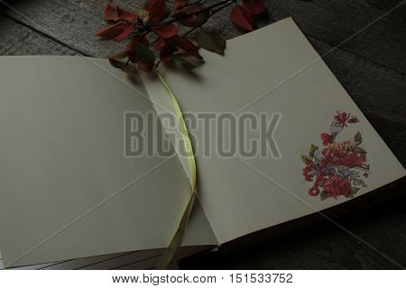 open Notepad with autumn culinary sticker rests on a wooden background.