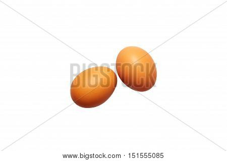 two fresh eggs on a white background. orange color. top view